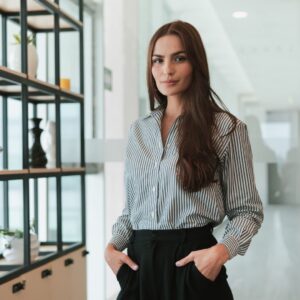 professional woman stands with hands in pockets